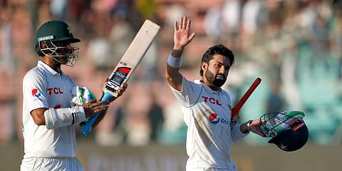 Mohammad Rizwan (R) and Nauman Ali wave to the crowd as they leave the ground at the end of the play of the second Test match between Pakistan and Australia at the National Stadium. (Photo | AP)
