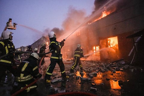 Ukrainian firefighters extinguish a blaze at a warehouse after a bombing in Kyiv, Ukraine, Thursday, March 17, 2022. (Photo | AP)