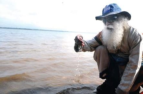 Sadguru Jaggi Vasudev drinking offering puja to Cauvery river on Friday. (Photo | EPS0
