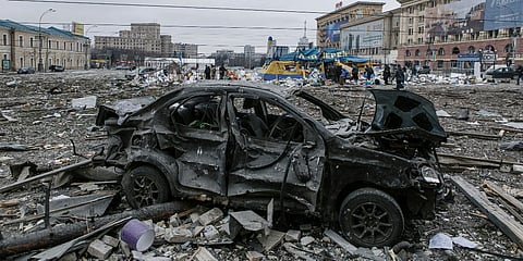 A damaged car sits at the central square following shelling of the City Hall building in Kharkiv. (Photo| AP)