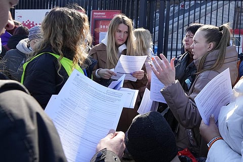 Ukrainian refugees talk near a special application point at the National Stadium in Warsaw, Poland, on Saturday, March 19, 2022. (Photo | AP)