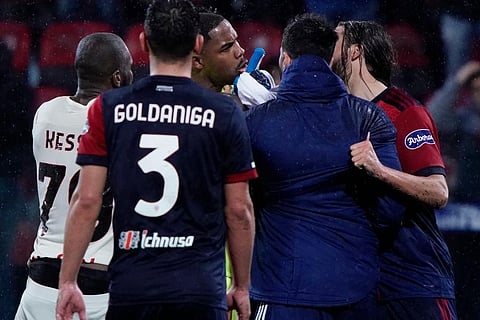 A.C. Milan goalkeeper Mike Maignan, center exchanges words with Cagliari's Leonardo Pavoletti, right, at a Serie A soccer match. ( Photo | AP)