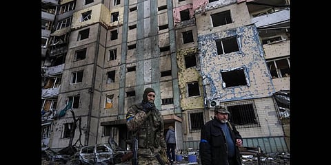 A soldier smokes a cigarette while walking next to a destroyed building after a bombing in Satoya neighborhood in Kyiv, Ukraine, Sunday, March 20, 2022(Photo | AP)