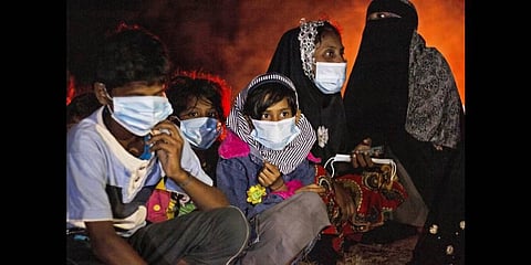 Ethnic Rohingya women and children sit by a fire on a beach after their boat was stranded on Idaman Island in East Aceh, Indonesia, late Friday, June 4, 2021(Photo | AP)