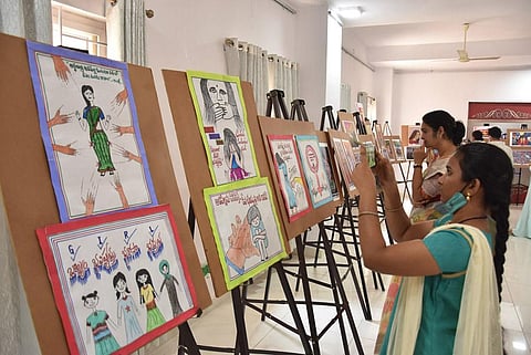 Women take a look at the paintings in the exhibition inaugurated at MBVK Bhavan in Vijayawada to mark Women’s Day on Tuesday. | Express