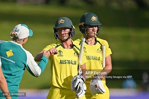 Annabel Sutherland and Meg Lanning of Australia leave the field victorious during the ICC 2022 Women's cricket world cup match. ( Photo | AFP)