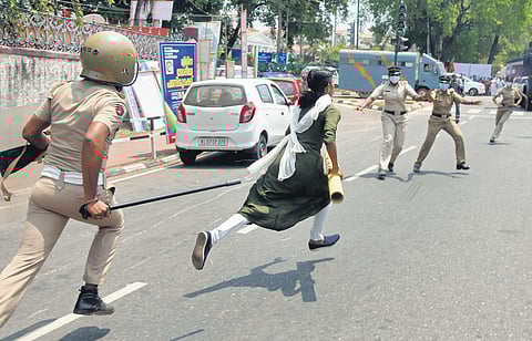 Anie Prasad J P, Vellarada block panchayat member being chased by police after she tried to lay a symbolic K-Rail survey stone during a protest. (Photo | B P Deepu, EPS)