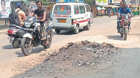 Commuters drive through a road that was damaged during the JICA work | Express