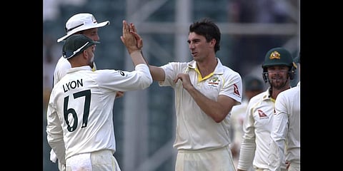 Australia's Pat Cummins celebrates after taking the wicket of Pakistan's Nauman Ali on the third day of the third test in Lahore, Pakistan, Wednesday, March 23, 2022.(Photo | AP)