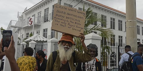 People protest to demand an apology and slavery reparations during a visit to the former British colony by, Prince William and Kate, in Kingston, Jamaica, Tuesday, March 22, 2022.(Photo | AP)