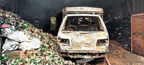 Workers clear the remains of an auto trolley that was gutted in the fire accident at a scrap godown at Bhoiguda on Wednesday | RVK Rao