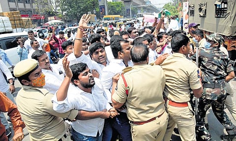 Police personnel stop an attempt by activists of tribal student unions, led by TRS leader G Srinivas, to lay siege to the BJP party office at Nampally on Wednesday demanding 12 per cent reservations f