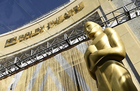 An Oscar statue is pictured underneath the entrance to the Dolby Theatre. (Photo | AP)