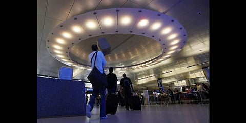 Arriving international passengers pass under a large 'halo' of light in the area where they meet friends and family, at the customs clearance area at the Tom Bradley Int Terminal(Photo | AP)