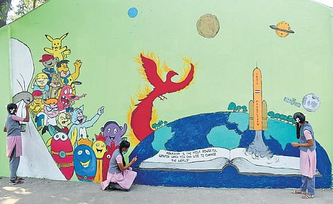Students of Dr MGR Cantonment High School paint the school campus wall at St Thomas Mount in Chennai city. (Photo | EPS)