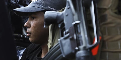 A young man is detained by the police, a suspect in a homicide near a market in San Salvador, El Salvador, Sunday, March 27, 2022.(Photo |AP)