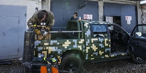Car welder Ostap Datsenko, 31, works on a vehicle that will be sent to soldiers on the frontlines, at a welding workshop in Lviv, western Ukraine, Sunday, March 27, 2022. (Photo | AP)