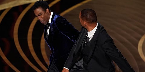 Will Smith(R) hits presenter Chris Rock on stage while presenting the award for best documentary feature at the 94th Academy Awards. (Photo| AP)