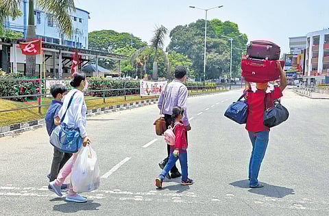 A four-member family that got stranded near Thiruvananthapuram Central railway station was forced to walk as buses and other modes of public transport remained off the road on Monday | B P Deepu