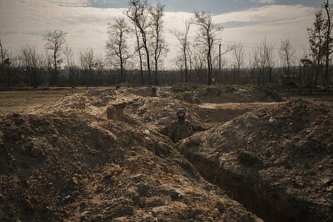 Ukrainian servicemen stand in trenches at a position north of the capital Kyiv, Ukraine, Tuesday, March 29, 2022. (Photo | AP)