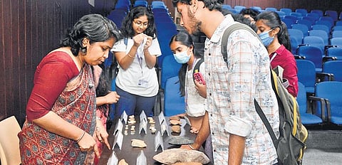 Superintendent Archaeologist Smita S Kumar shows some artefacts to students in Hyderabad on Monday. ( Photo | EPS)