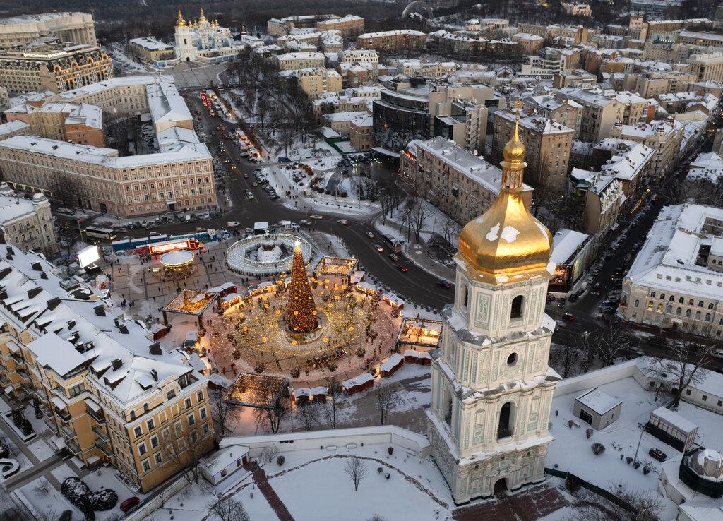 Snow covers the city center with a Christmas tree, St. Sophia Cathedral, foreground, and St. Michael Cathedral, background, in Kyiv. (Photo | AP)