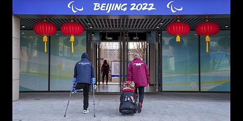 Neutral athletes with re-branded clothing arrive at the Paralympic Village. Tape is seen covering the word 'Russia' on the back of an athlete's jacket.(Photo | AP)