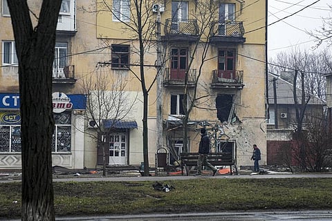A man walks past an apartment building hit by shelling in Mariupol, Ukraine, Wednesday, March 2, 2022. (Photo | AP)