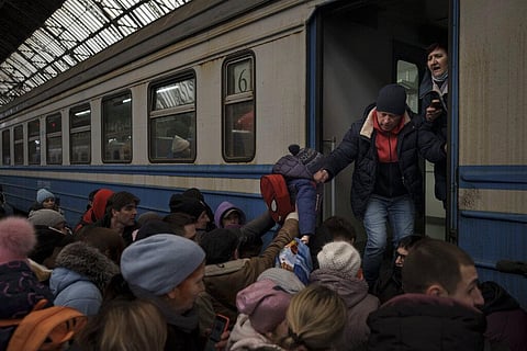 Passengers rush to board a train leaving to Slovakia from the Lviv railway station on Wednesday (Photo | AP)