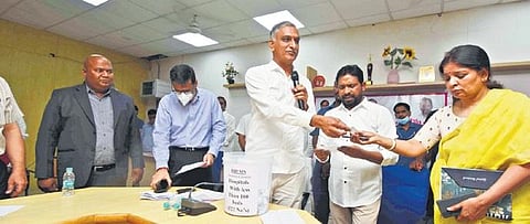 Health Minister T Harish Rao picks out names of hospitals where a new policy of reserving 16% tenders for SCs will be enforced. ( Photo | EPS)