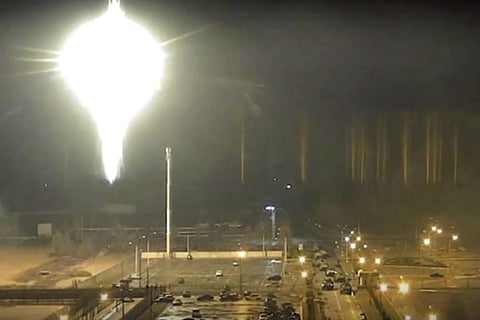 This image made from a video released by Zaporizhzhia nuclear power plant shows bright flaring object landing in grounds of the nuclear plant in Enerhodar, Ukraine. (Photo | AP)