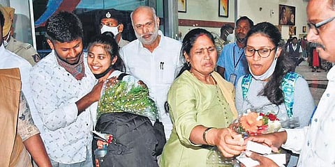 Families receive their children in the presence of minister Shivaram Hebbar in Hubballi on Thursday. (Photo | EPS)