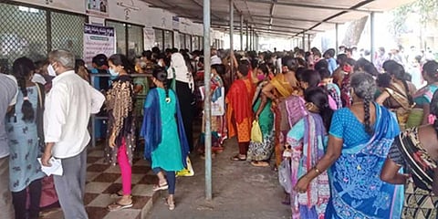 People in large numbers standing in queue to get OP tickets as there are not enough systems to issue tickets at GGH in Kakinada | Express.