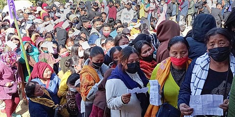 Voters holding their identification cards stand in queues to cast their votes for the second phase of Manipur Assembly elections, in Senapati. (Photo | PTI)