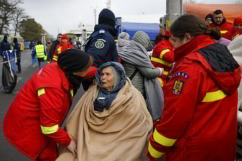 Emergency Situations Department employees talk to wheelchair user Katia, 90 years-old, a refugee fleeing the conflict from neighbouring Ukraine. (Photo | AP)
