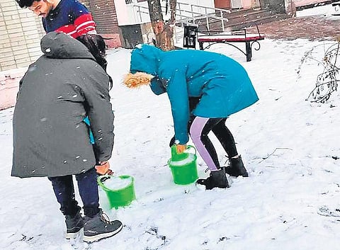 Students collect ice to melt for drinking water
