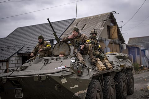 Ukrainian soldiers drive on an armored military vehicle in the outskirts of Kyiv, Ukraine, Saturday, March 5, 2022. (AP Photo)