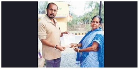 Sukumar giving his push card to a voter in Ward 19 of Baripada town. (Photo | Express)