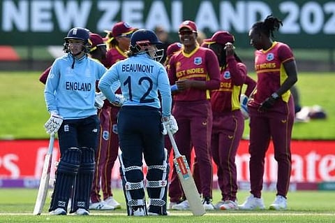 England's Tammy Beaumont (2nd L) and Danni Wyatt (L) wait for the third umpire's decision during the Round 2 Women's Cricket World Cup match between England and West Indies in Dunedin. (Photo | AFP)