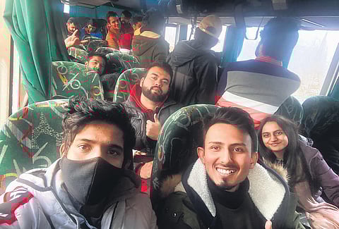 Students strike a happy pose as they board buses to Poltava. (Photo| Special Arrangement)