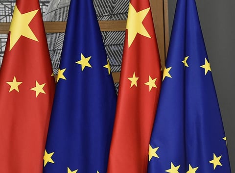 EU and Chinese flags are seen at the Europa building in Brussels. (File Photo | AP)