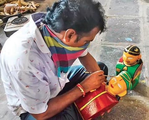 A craftsman paints a wooden toy at Kondapalli, about 25 km from Vijayawada. (Photo | EPS, Prasant Madugula)