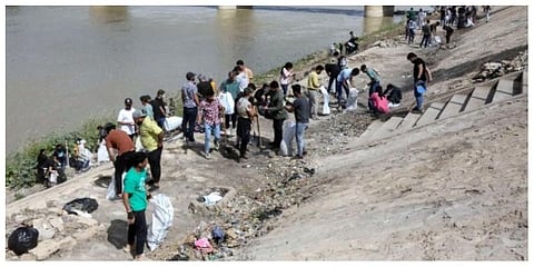 Young Iraqi volunteers take part in a clean-up campaign on the bank of the Tigris river in the Adhamiyah district of the capital Baghdad. (Photo | AFP)