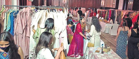 Attendees browsing through various stalls at the Design Show