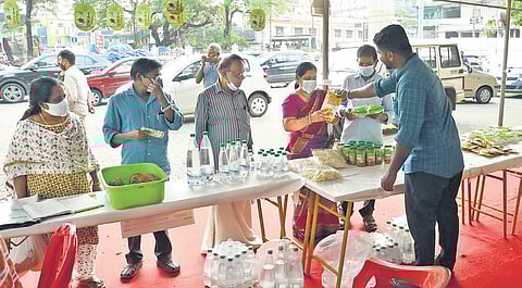 People selecting products from the stall by Varappetty Service Cooperative Society during the ‘Jaivakarshikolsavam’ in Ernakulam Town hall on Sunday | Arun Angela