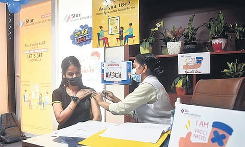 A beneficiary receives the booster dose in New Delhi on Sunday. (Photo | Parveen Negi)