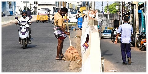 File photo of sanitation workers cleaning Thennur bridge in Tiruchy. (Photo | MK Ashok Kumar)