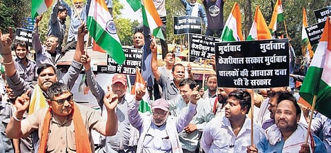 Auto-taxi union members raise slogans in front of the secretariat on Monday | PTI