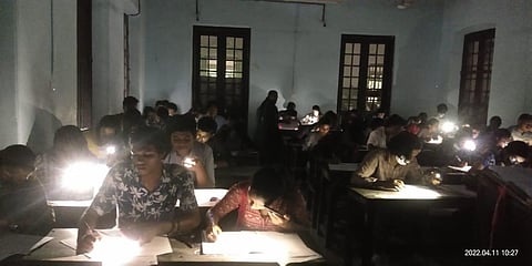 IN KERALA: Students writing exam with the help of their mobile flashlights at the prestigious Maharajas College in Ernakulam on Monday, April 11, 2022.