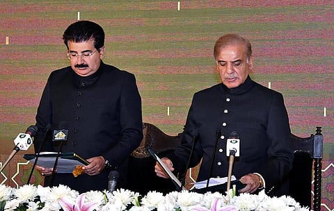 Acting President of Pakistan Sadiq Sanjrani, left, administers the oath of office to newly elected Pakistani Prime Minister Shehbaz Sharif during a ceremony at Presidential Palace. (Photo | AP)